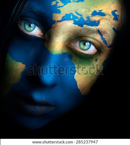 Planet earth painted on woman face, Elements of this image furnished by NASA