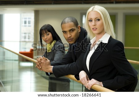 A beautiful business woman at office building with work colleges in the background