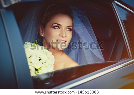 Portrait of a beautiful young bride in the car
