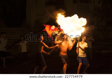 Hanoi, Vietnam - Sep 27, 2012: Artists perform fire blowing on street on Vietnamese mid autumn festival day