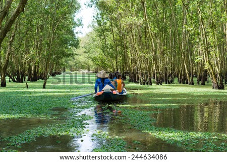 Tourism rowing boat in Tra Su flooded indigo plant forest in An Giang, Mekong delta, Vietnam