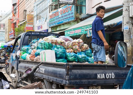 Vinh Long, Vietnam - Nov 30, 2014: Light deliver truck loaded full with tropical fruits at Vinh Long market, Mekong delta