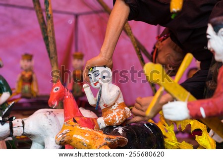 Hanoi, Vietnam - Feb 7, 2015: Common Vietnamese water puppets behind puppetry state at Vietnamese lunar new year festival organized at Vinschool, Vinhomes Times City, Minh Khai