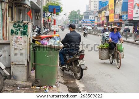 Hanoi, Vietnam - Mar 15, 2015: Wide view of Hanoi street focusing on rubbish bin. The word \