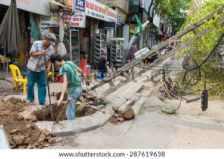Hanoi, Vietnam - June 14, 2015: Fallen electrical pole damaged on street by natural heavy wind storm in Kim Nguu street