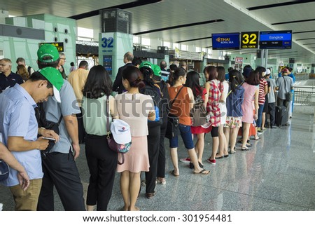 Hanoi, Vietnam - June 26, 2015: Lines of people waiting at boarding gate in Noi Bai International Airport