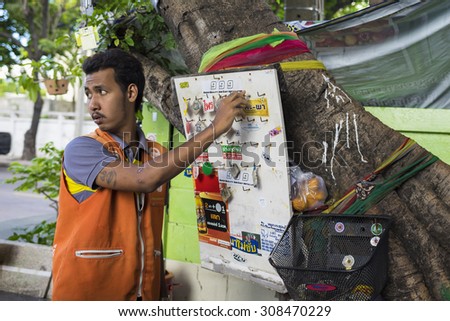 Bangkok, Thailand - June 29, 2015: Motorcycle Taxi changes name tag in queue table. The Taxis waiting for customer at street corner. The longest in waiting time driver will have customer firstly