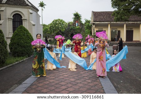 Ninh Binh, Vietnam - May 16, 2015: Vietnamese Christian women perform an old traditional dance on \