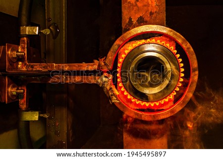 closeup calcining hot metal steel gear parts in a factory induction furnace with smoke and flame Photo stock © 