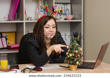 Girl in the office, decorated for new year