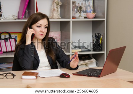 employee of office is telephone conversation with a worried expression on his face