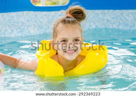 Six year old girl Europeans bathed in a small suburban pool
