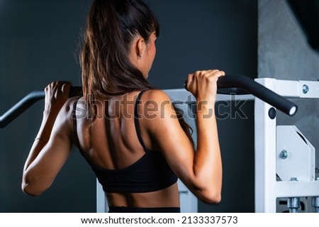 Image, Stock Photo Female athlete doing pull up exercises