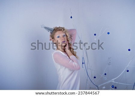 Beautiful girl in the image of the Snow Queen in the studio