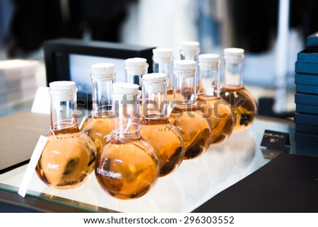 Bottles of orange perfumes in a shop.
