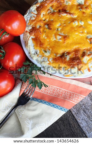 Freshly baked tomato pie with tomatoes on the vine.