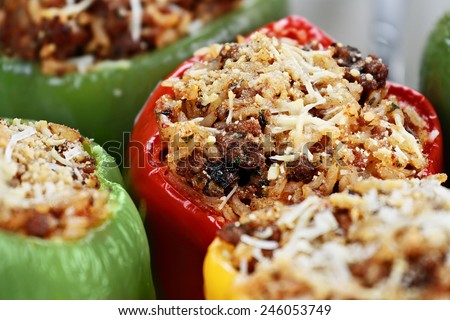 Baked bell peppers stuffed with beef, rice, vegetables and cheese with extreme shallow depth of field.