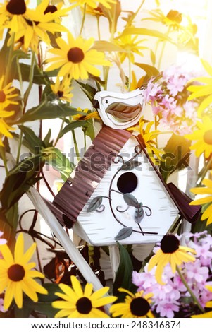 Digital painting of a little bird house with black eyed susans and garden phlox.