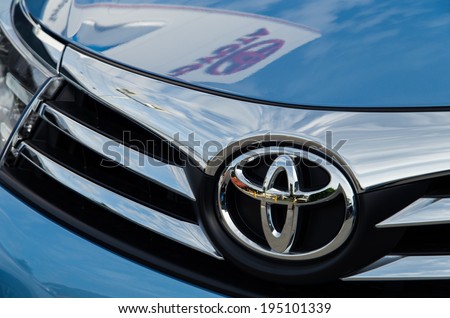 MELBOURNE, AUSTRALIA - May 25, 2014: Toyota Corolla motor vehicle in a Toyota dealership.  The dealership\'s sign is reflected in the vehicle\'s bonnet.