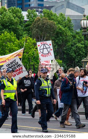 MELBOURNE, AUSTRALIA - November 16, 2014: protesters and police at a political demonstration in Melbourne against the Prime Minister Tony Abbott / Liberal Party federal government.
