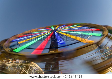 Bright lights on a fairground ride at night