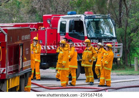 MELBOURNE, AUSTRALIA - February 10, 2015: Volunteer fire fighters from the North Warrandyte brigade of the Country Fire Authority practicing by the Yarra River in Warrandyte, with Isuzu fire trucks.