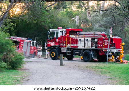 MELBOURNE, AUSTRALIA - February 10, 2015: Volunteer fire fighters from the North Warrandyte brigade of the Country Fire Authority practicing by the Yarra River in Warrandyte, with Isuzu fire trucks.