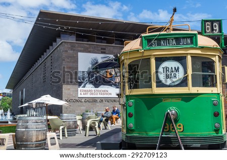 Melbourne, Australia - November 9, 2013: Tram Bar is situated outside the Arts Centre on St Kilda Road. It is situated in a vintage W-Class tram. In the background stands National Gallery of Victoria.