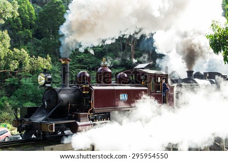 Dandenong Ranges, Australia - May 11, 2014: Puffing Billy tourist steam train crossing a bridge near Belgrave. Puffing Billy is a major tourist attraction near Melbourne, Australia.