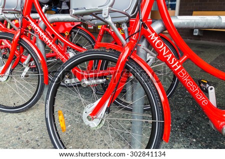 Melbourne, Australia - August 2, 2015: red bicycles of the on-campus share bike scheme at the Monash University Clayton campus.