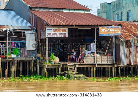 Can Tho, Vietnam - August 12, 2015: simple business premises, built on stilts, backing onto the Can Tho River in the Mekong Delta region.
