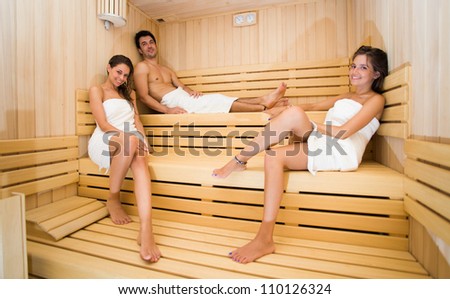 Group of people doing a sauna bath in a steam room