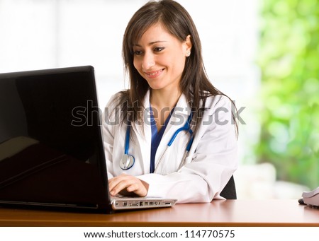 Portrait of a doctor using her personal computer