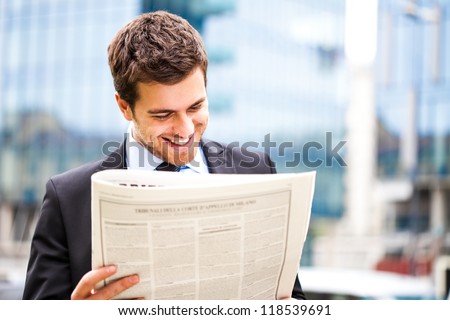 Business man reading a newspaper