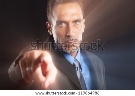 Confident businessman pointing his finger at you
