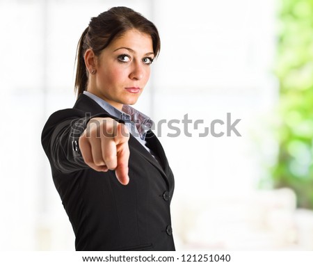 Serious businesswoman pointing at you