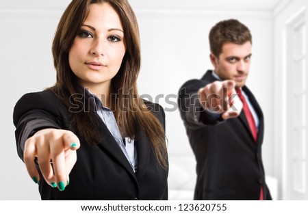 Business people pointing their fingers at you