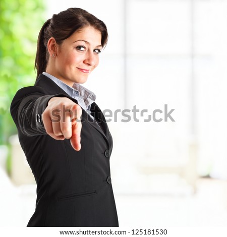 Beautiful businesswoman pointing her finger at you