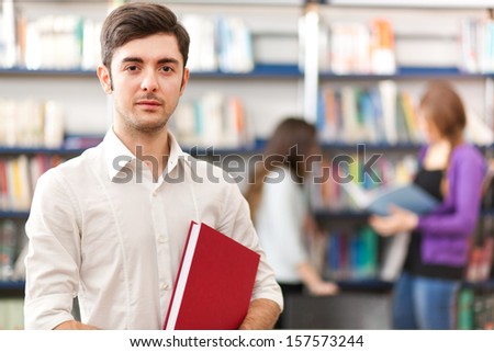 Male student portrait in a library