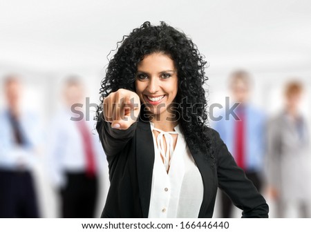 Businesswoman pointing her finger at you