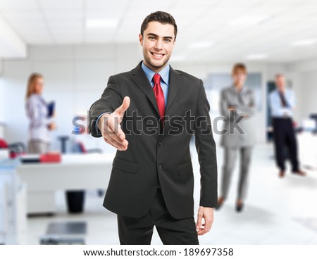 Portrait of an handsome businessman giving an handshake