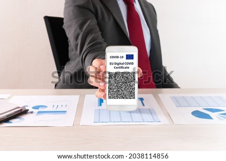 Businessman showing his european covid vaccine certificate, also called Green Pass Stock foto © 