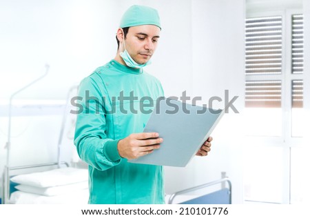 Portrait of a surgeon reading a case history