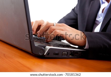 Closeup of male hands typing on a laptop