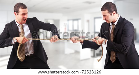 Businessmen twins pulling a rope in an office environment