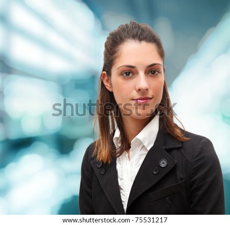 Portrait of a young successful businesswoman. Blue blurred background.