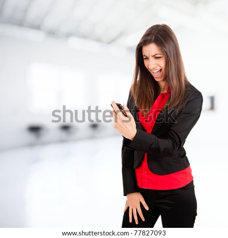 Angry young business woman yelling at her phone