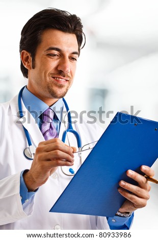 Portrait of an experienced doctor looking at a case history
