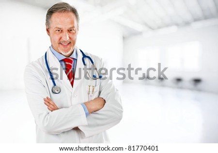 Portrait of a senior doctor in a clinic hall