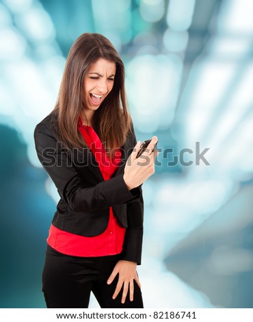 Angry young business woman yelling at her phone